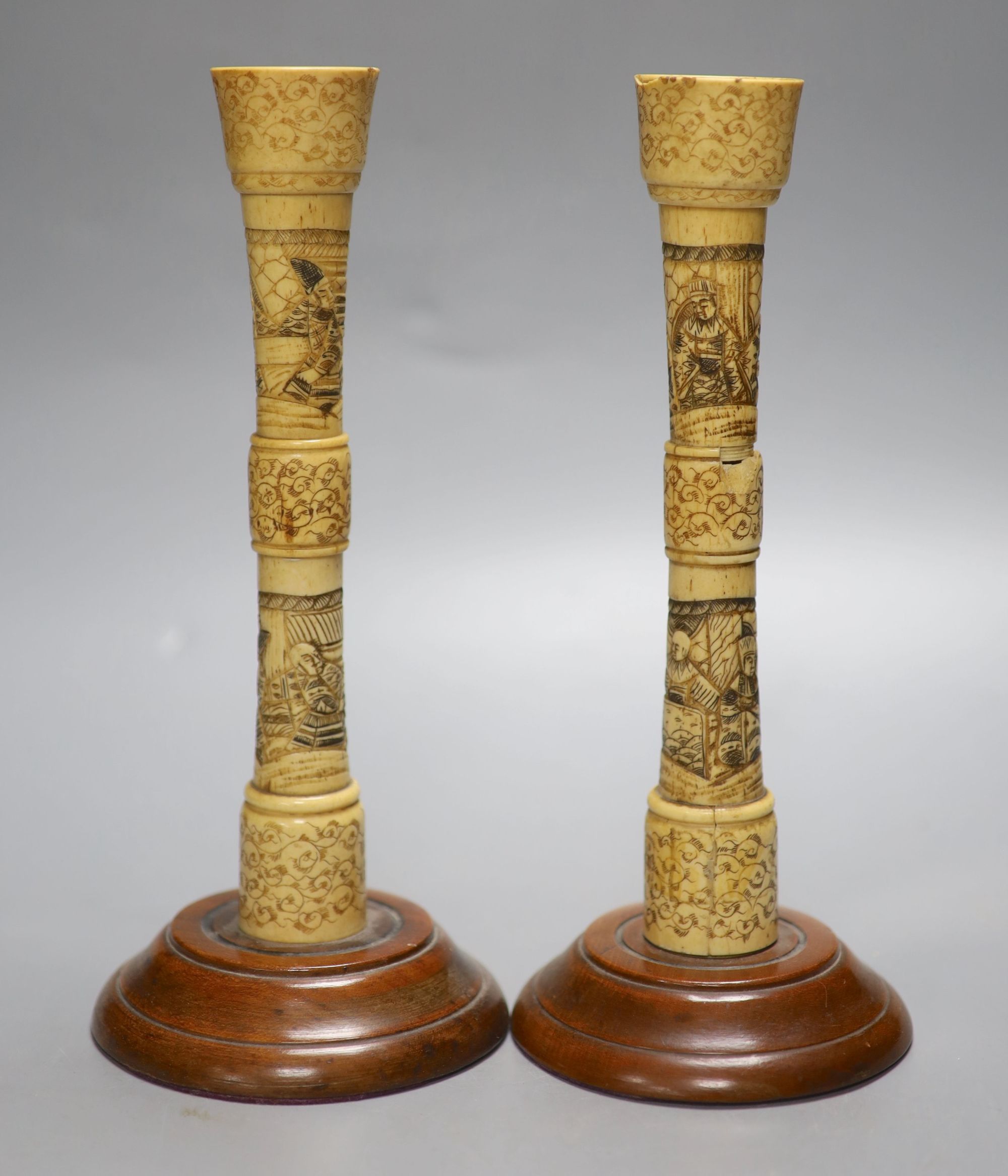 A pair of carved bone candlesticks, Meiji period, height 25cm